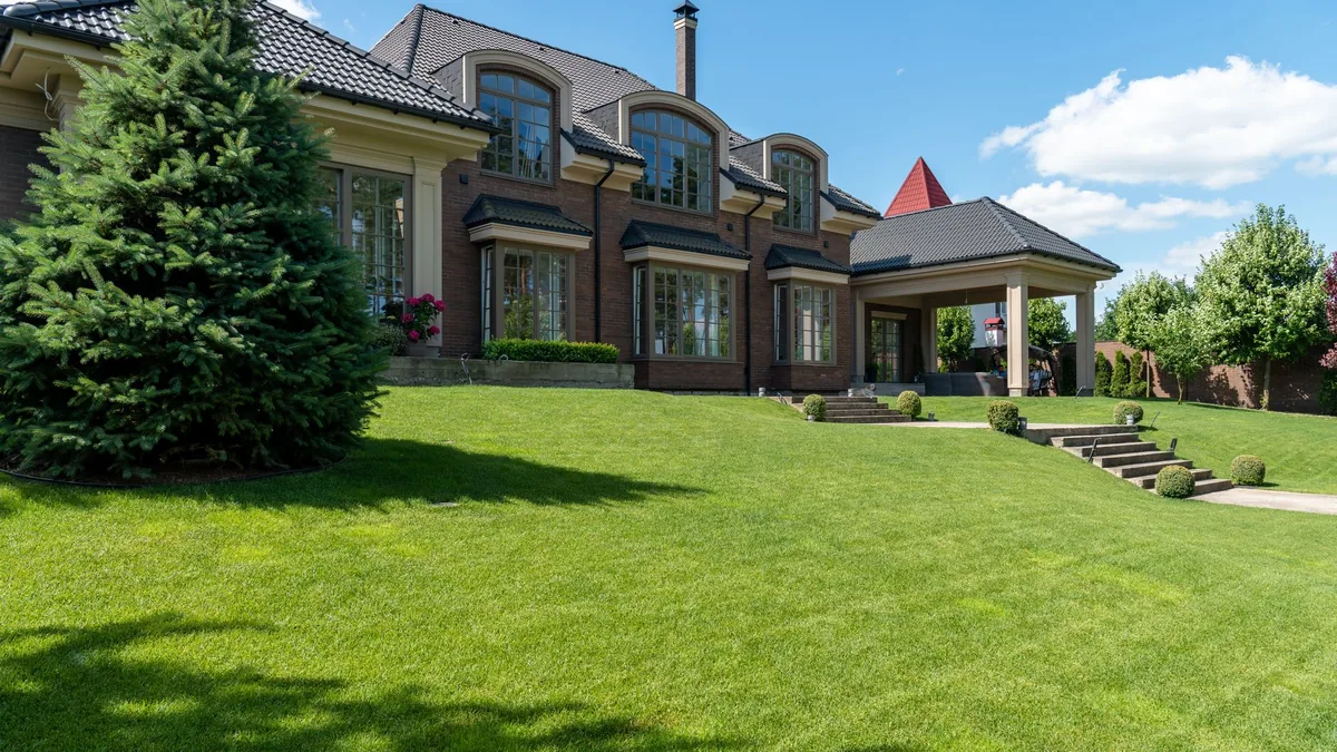 A large home in Gastonia behind a wide, freshly mowed green lawn with clean edges